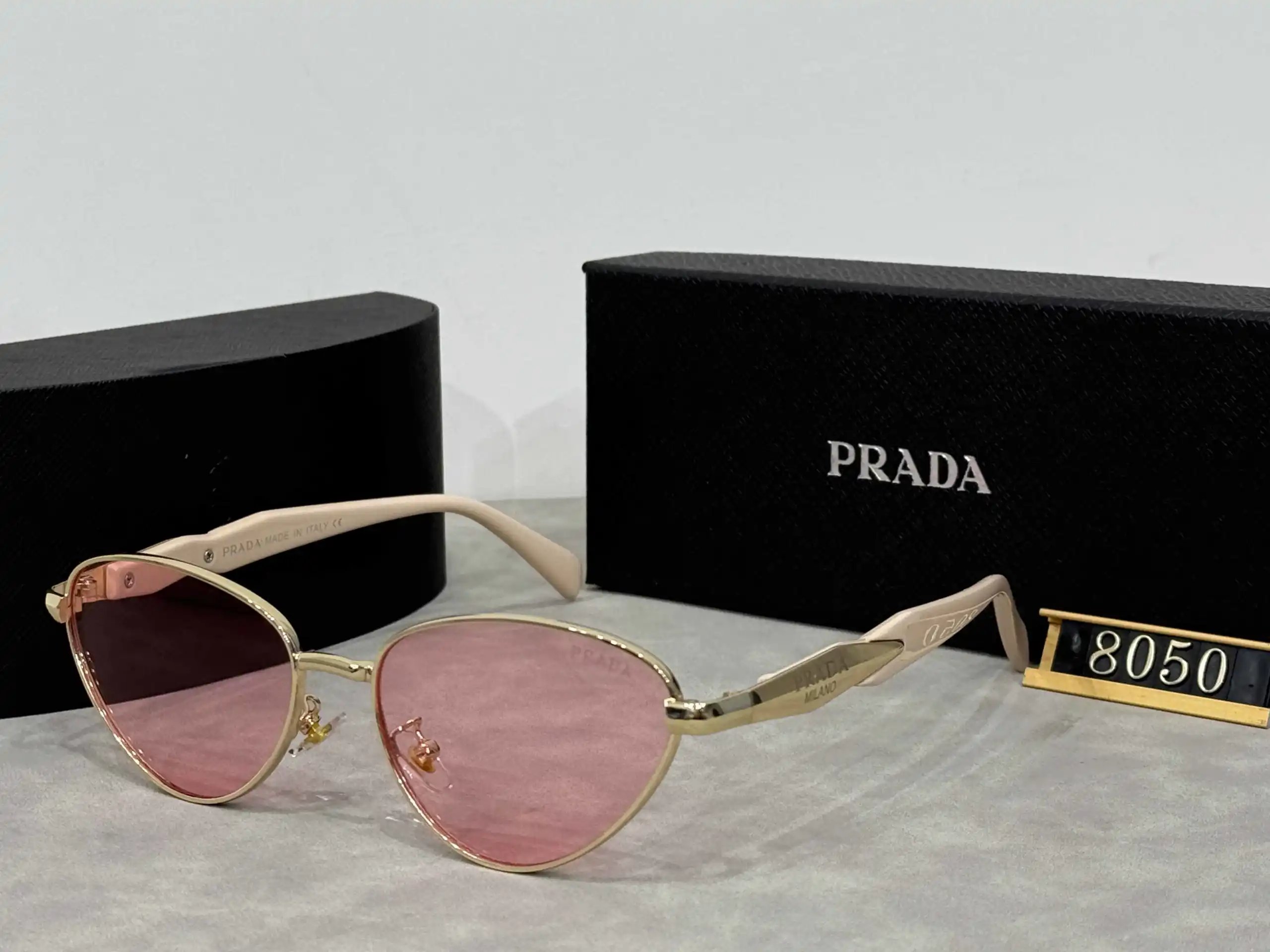 Prada Eyewear Assorted geometric-frame sunglasses with triangle logo plaques — 1