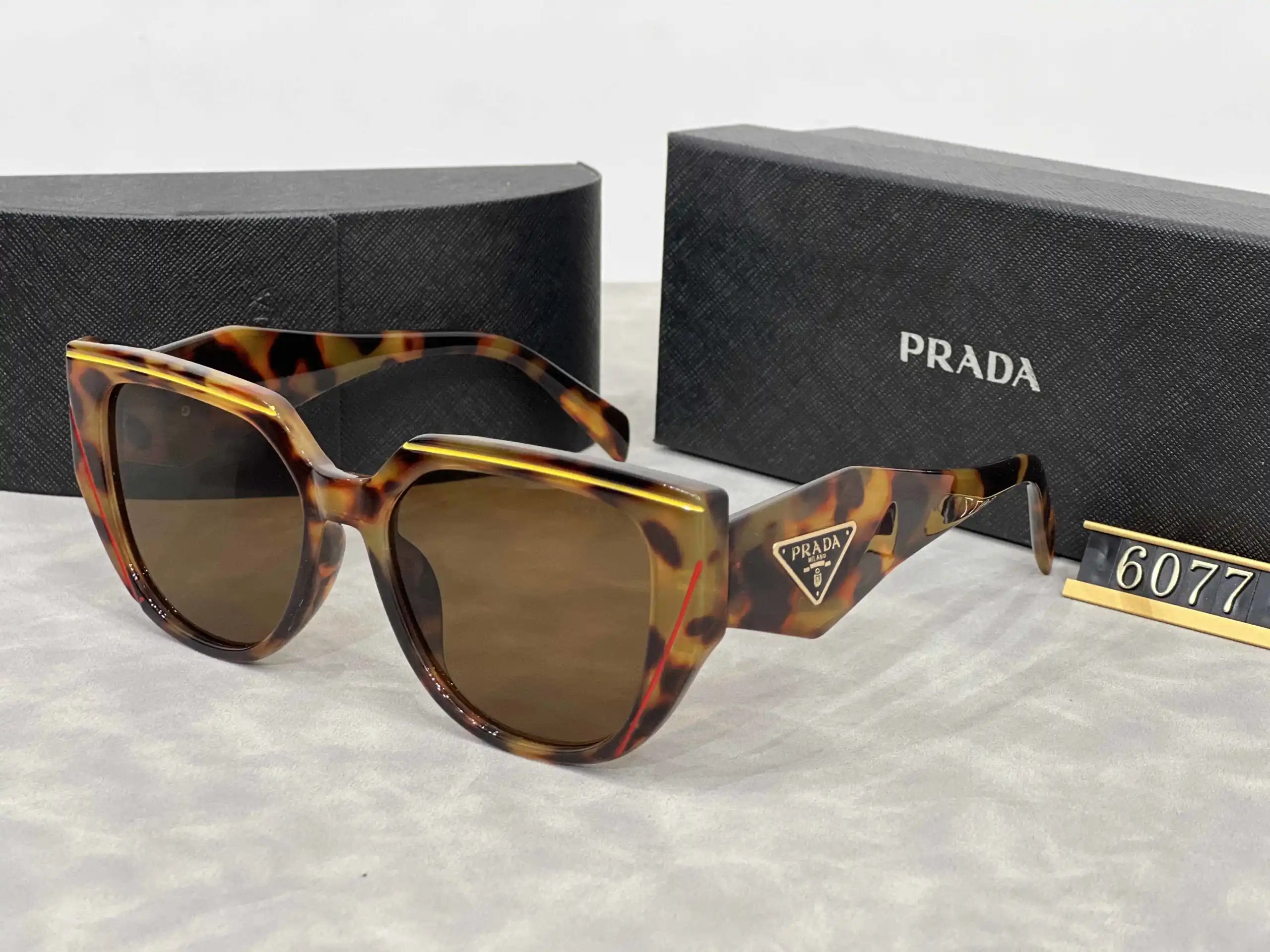 Prada Eyewear Assorted geometric-frame sunglasses with triangle logo plaques — 20