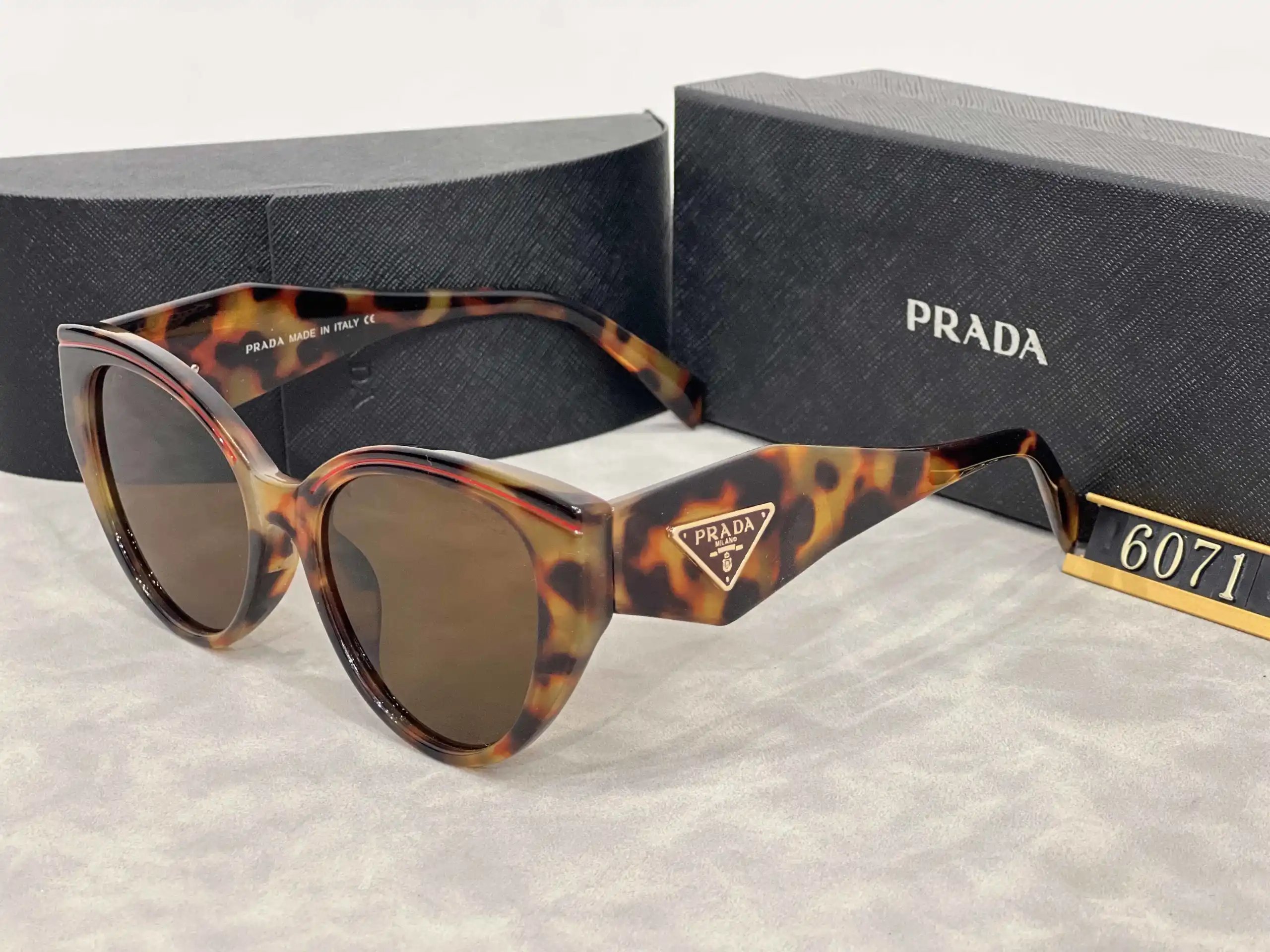 Prada Eyewear Assorted geometric-frame sunglasses with triangle logo plaques — 9
