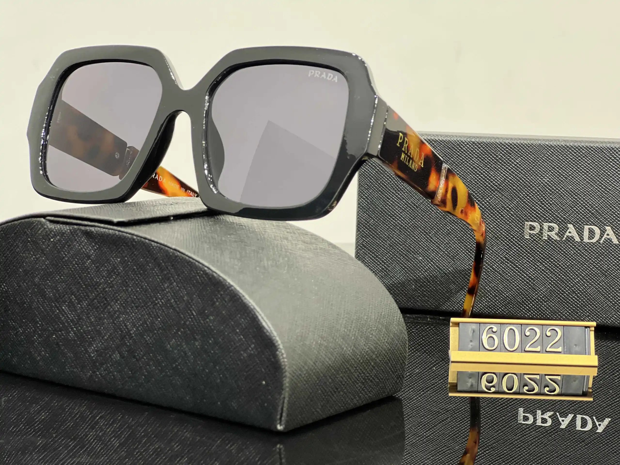 Prada Eyewear Assorted geometric-frame sunglasses with triangle logo plaques — 13