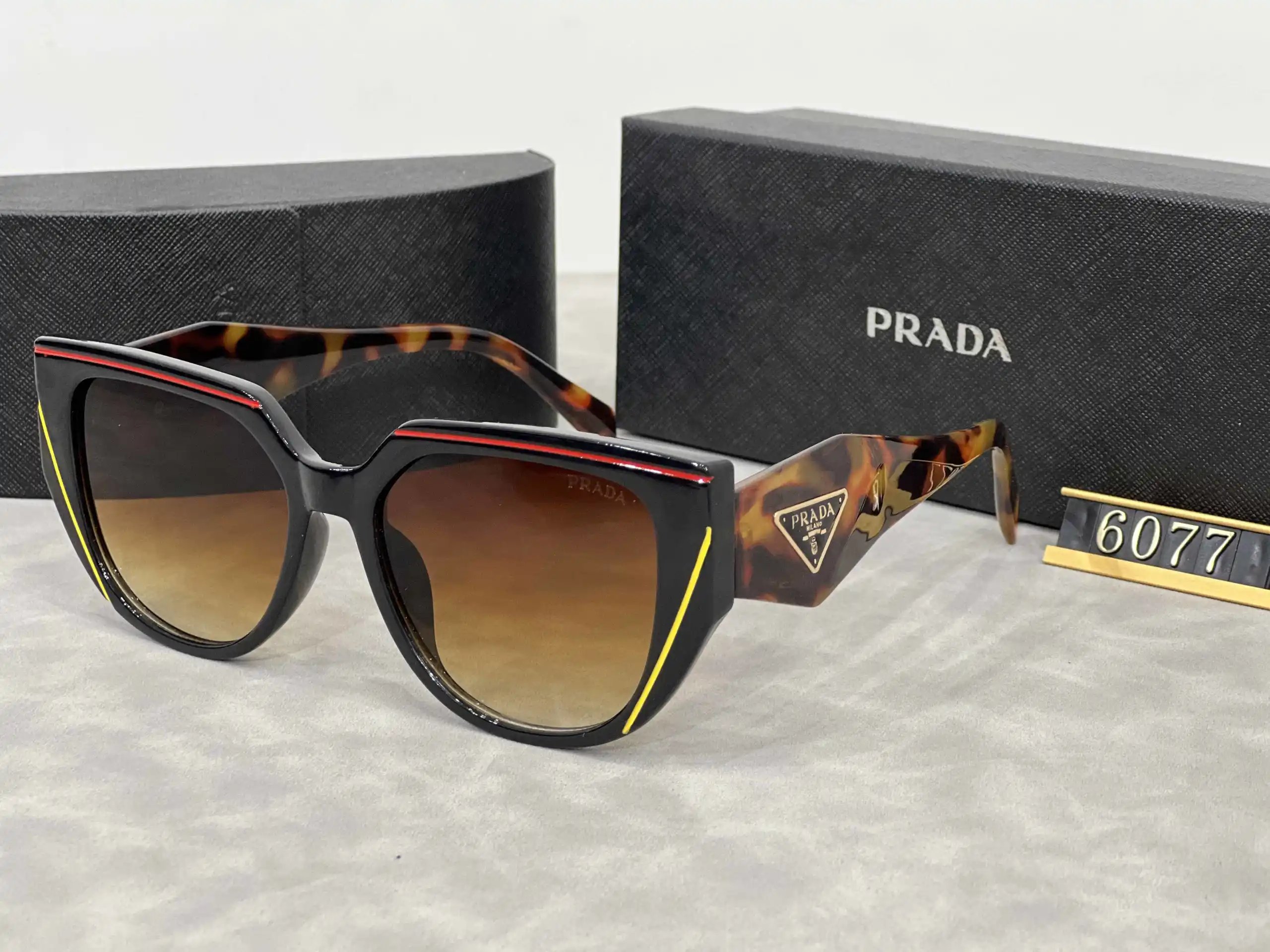 Prada Eyewear Assorted geometric-frame sunglasses with triangle logo plaques — 25