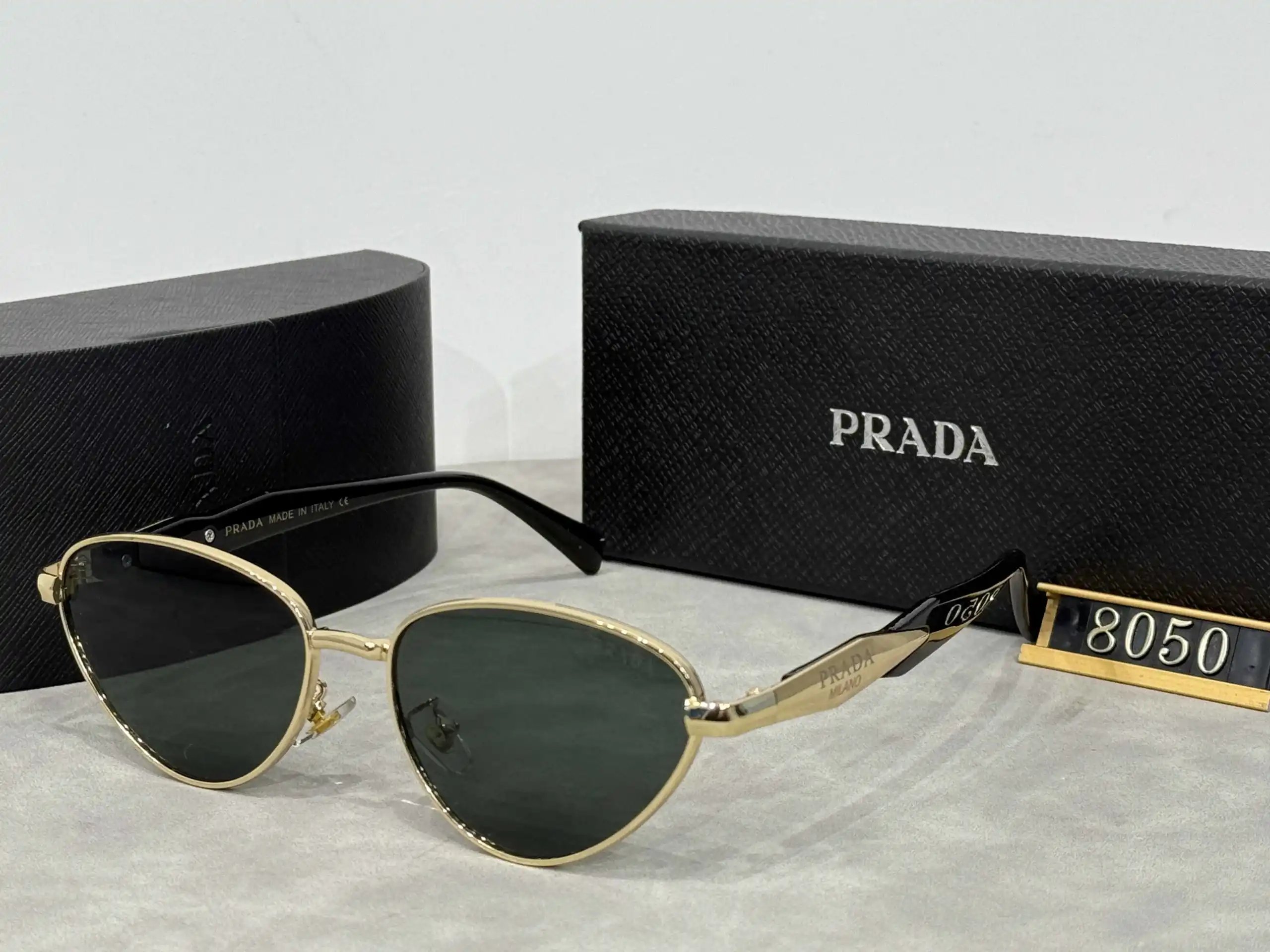 Prada Eyewear Assorted geometric-frame sunglasses with triangle logo plaques — 17