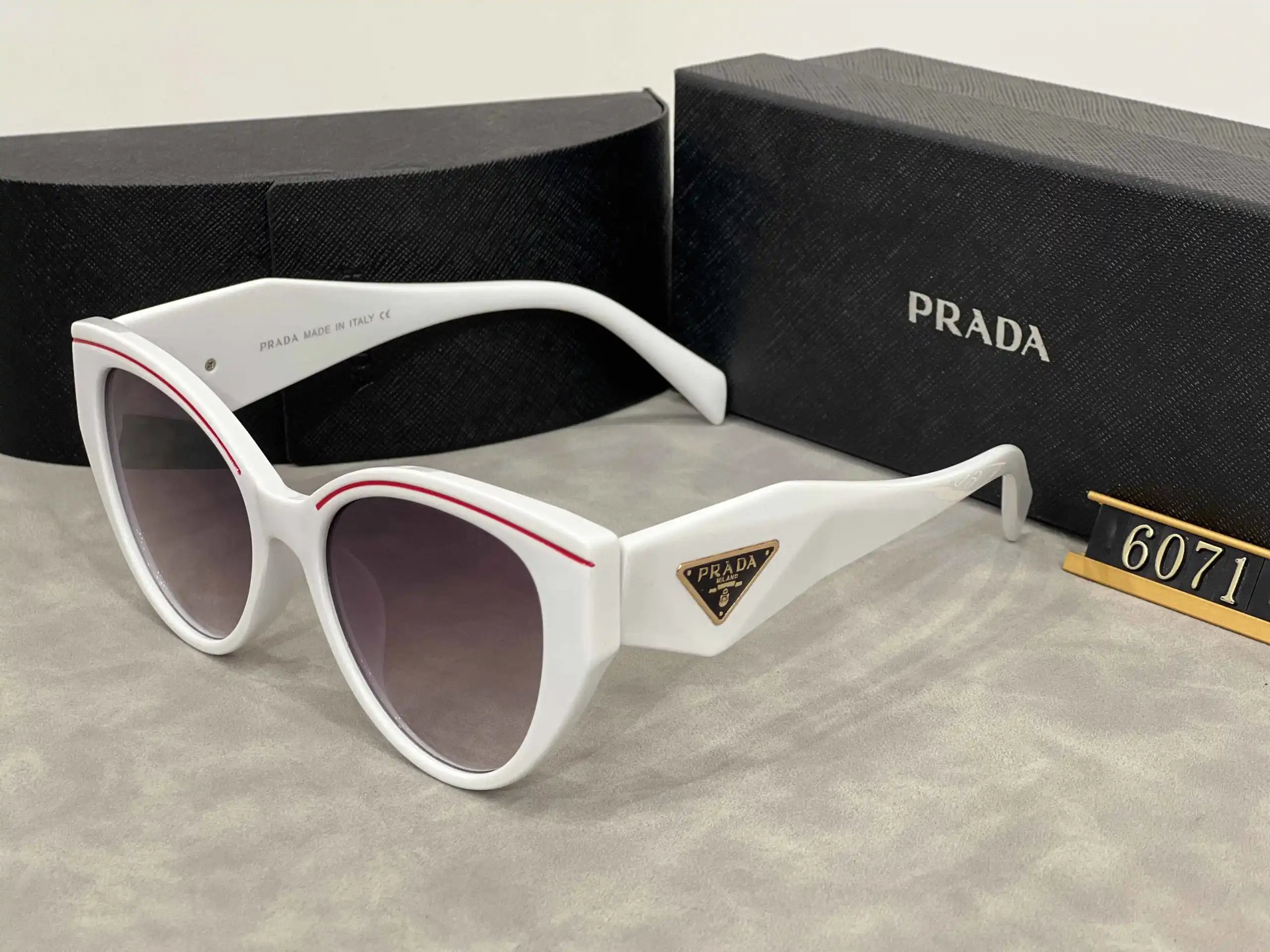Prada Eyewear Assorted geometric-frame sunglasses with triangle logo plaques — 30