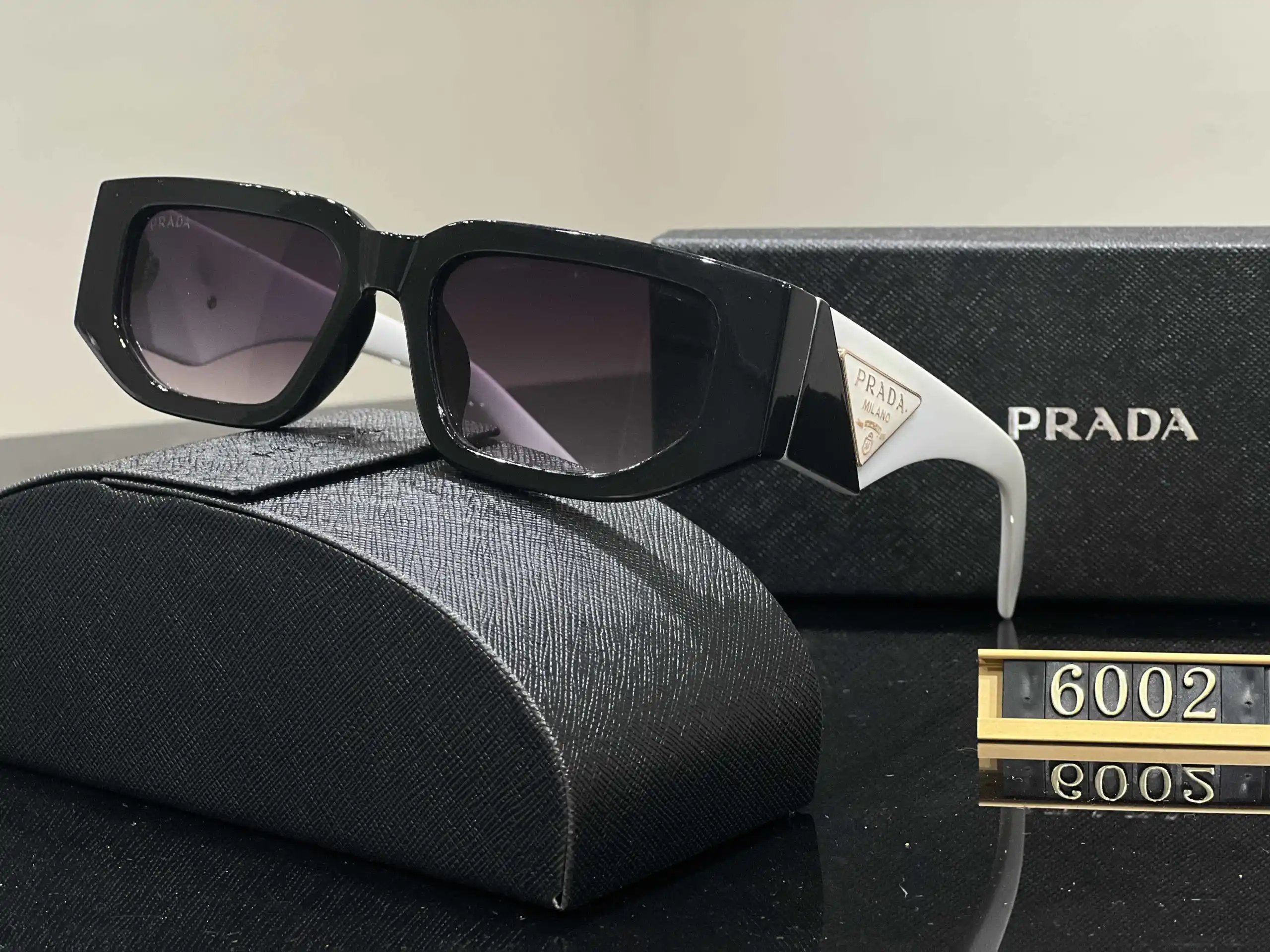 Prada Eyewear Assorted geometric-frame sunglasses with triangle logo plaques — 40