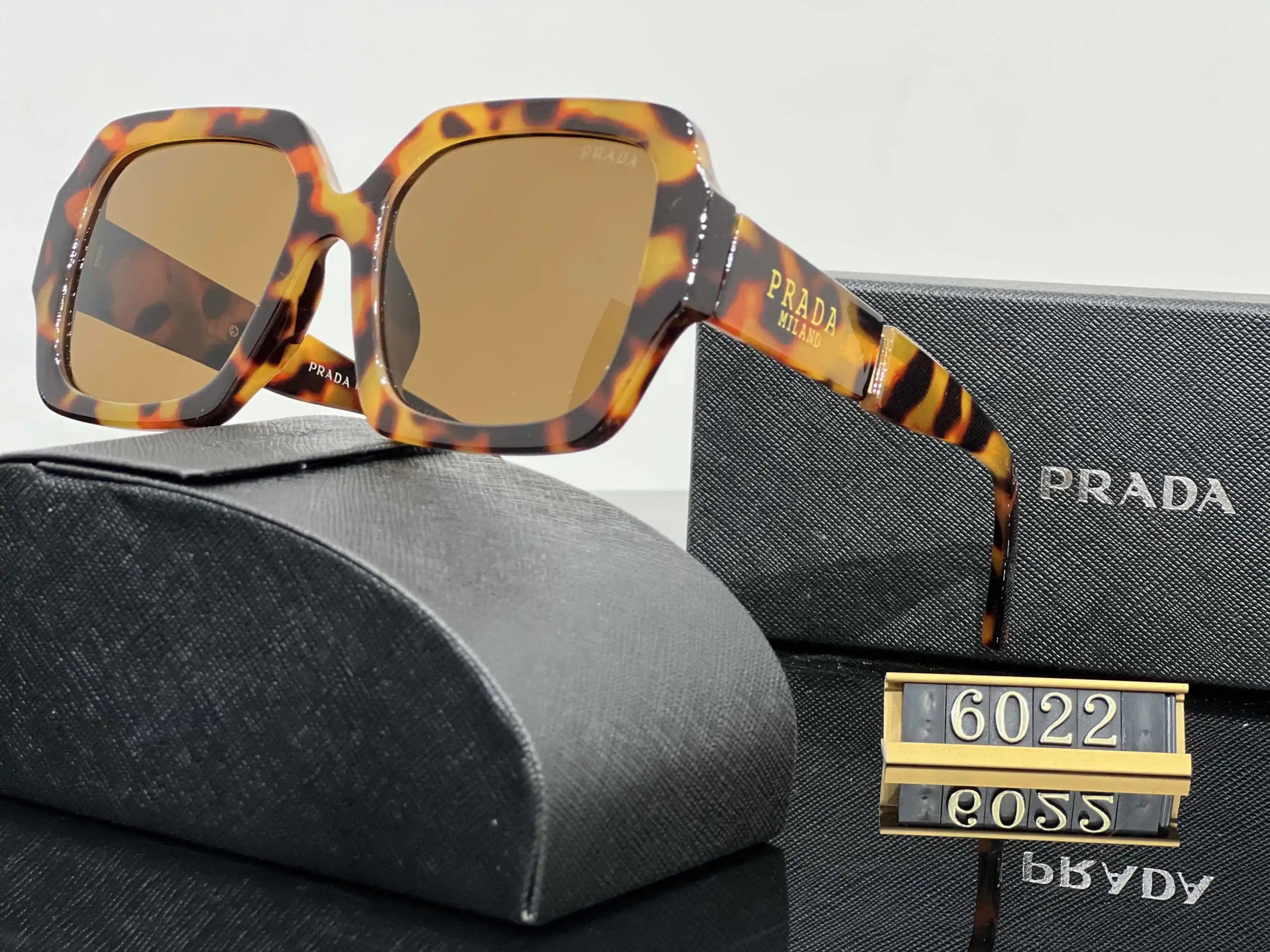 Prada Eyewear Assorted geometric-frame sunglasses with triangle logo plaques — 38