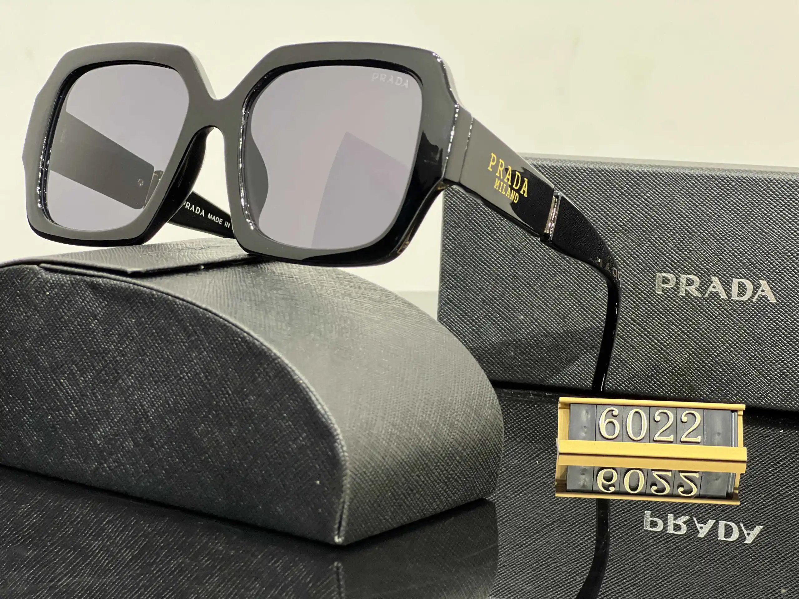 Prada Eyewear Assorted geometric-frame sunglasses with triangle logo plaques — 36