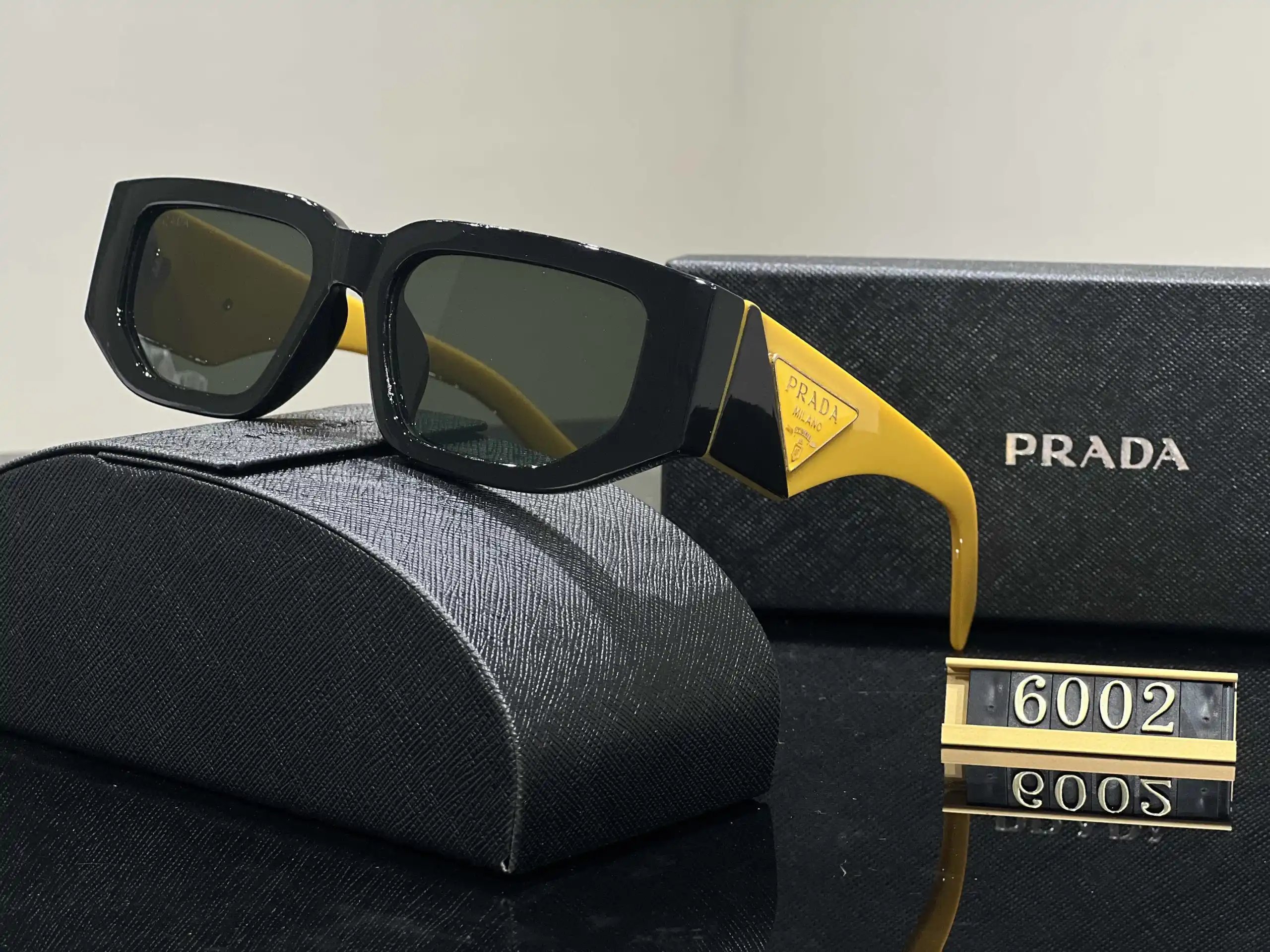 Prada Eyewear Assorted geometric-frame sunglasses with triangle logo plaques — 14