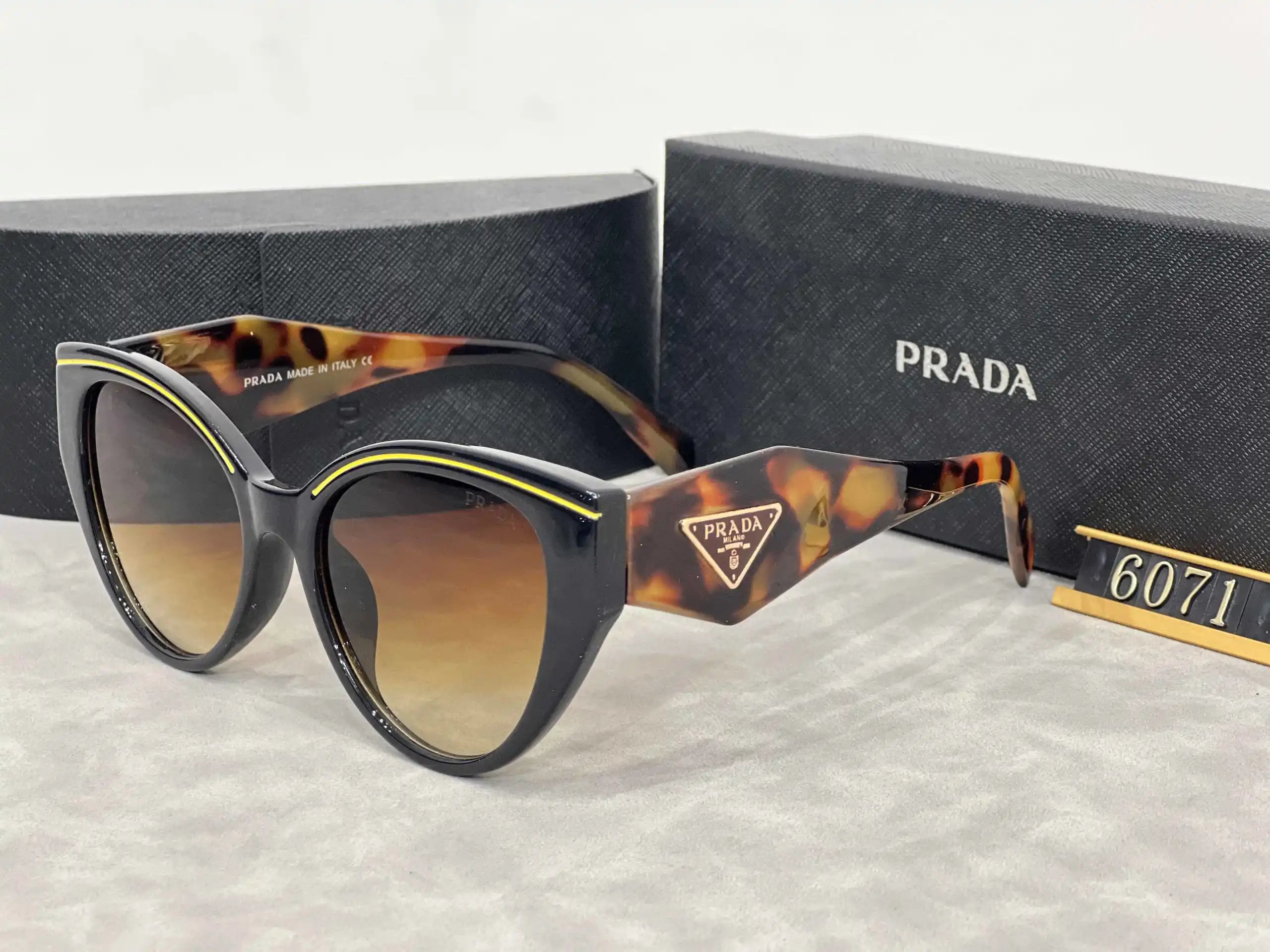 Prada Eyewear Assorted geometric-frame sunglasses with triangle logo plaques — 29