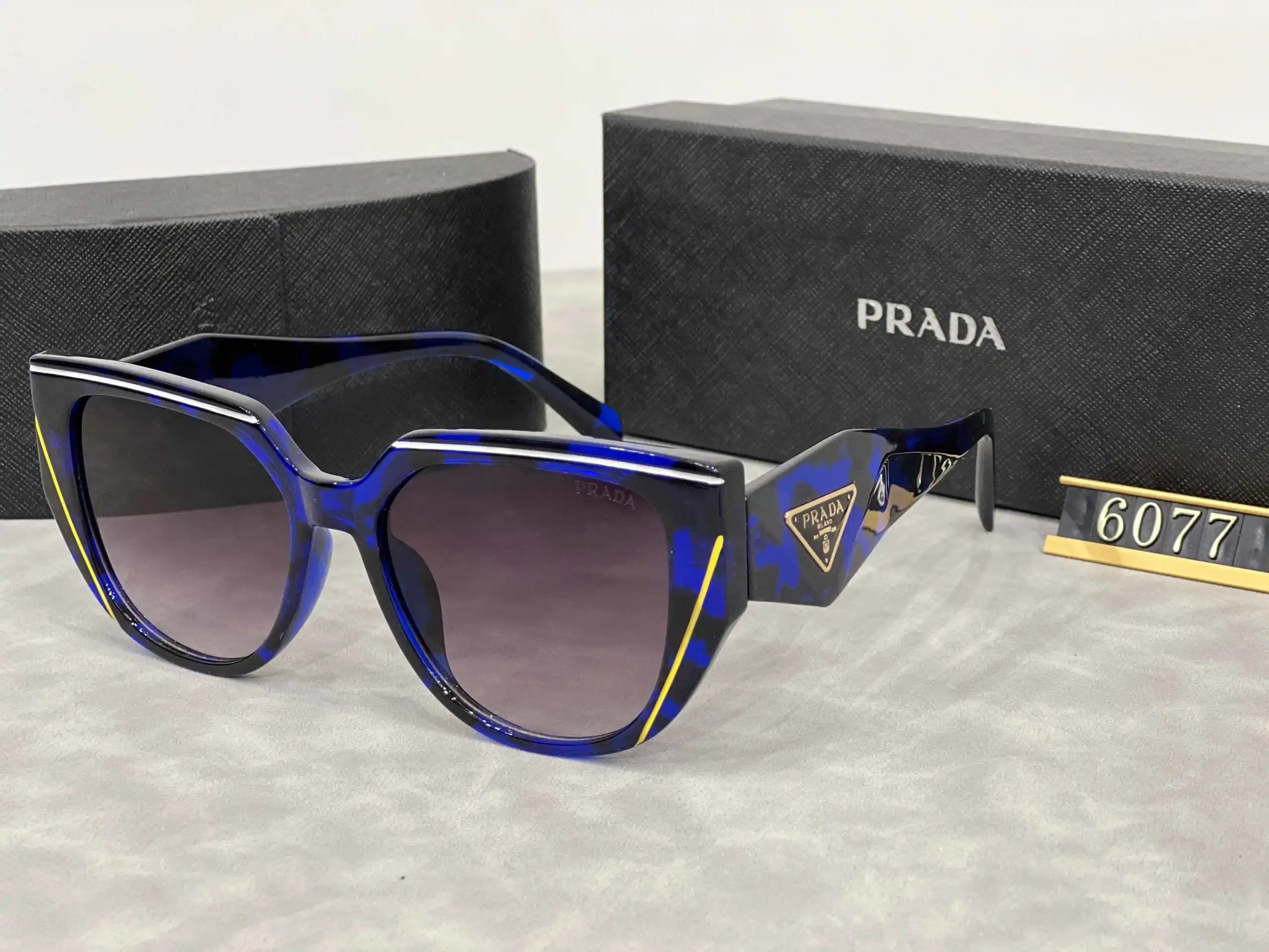 Prada Eyewear Assorted geometric-frame sunglasses with triangle logo plaques — 24