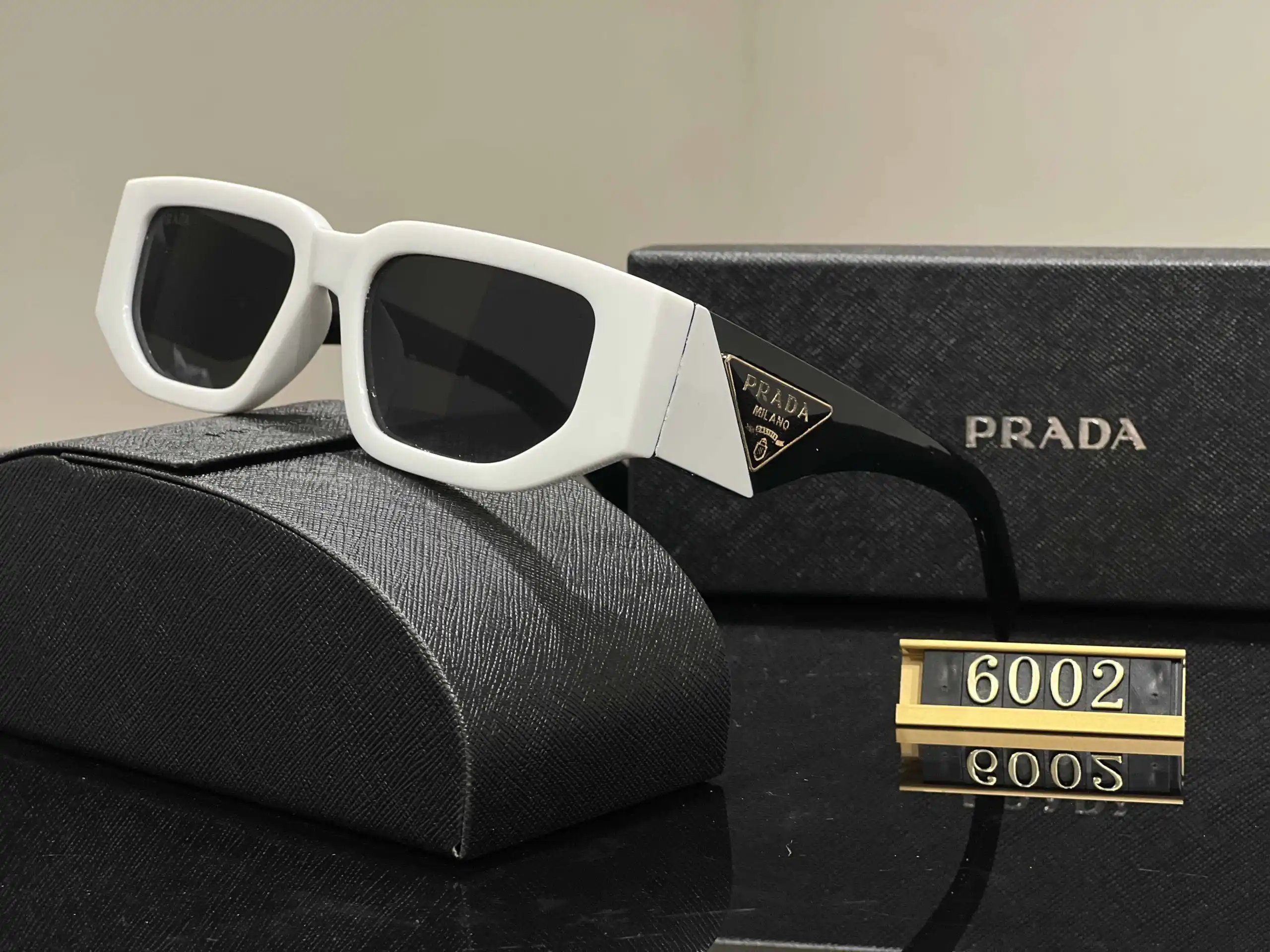 Prada Eyewear Assorted geometric-frame sunglasses with triangle logo plaques — 37