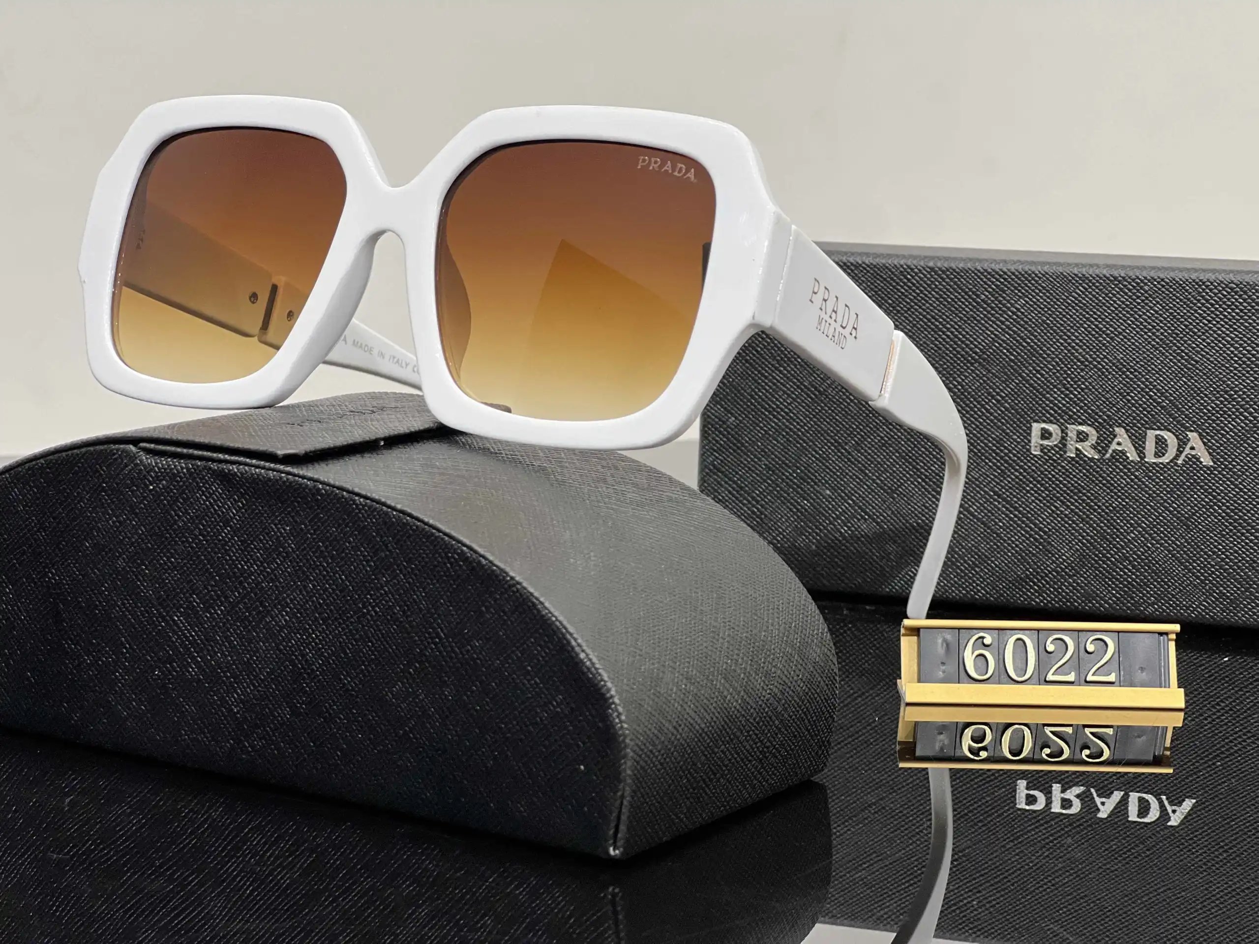 Prada Eyewear Assorted geometric-frame sunglasses with triangle logo plaques — 12