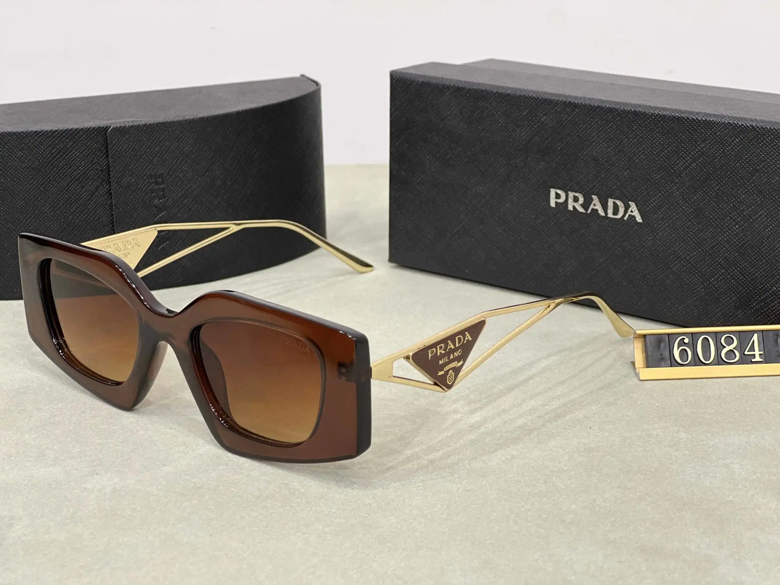 Prada Eyewear Assorted geometric-frame sunglasses with triangle logo plaques — 21