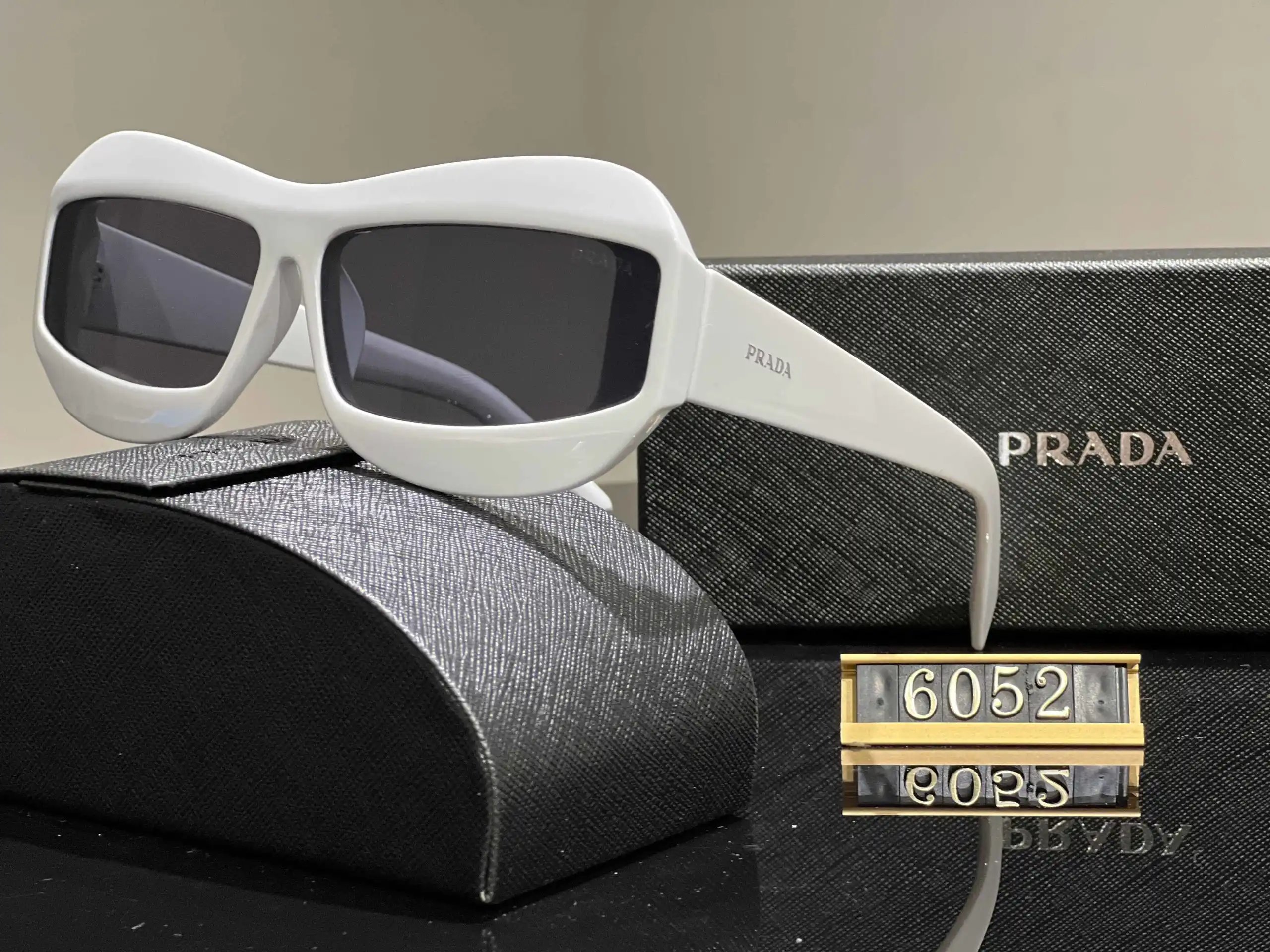 Prada Eyewear Assorted geometric-frame sunglasses with triangle logo plaques — 33