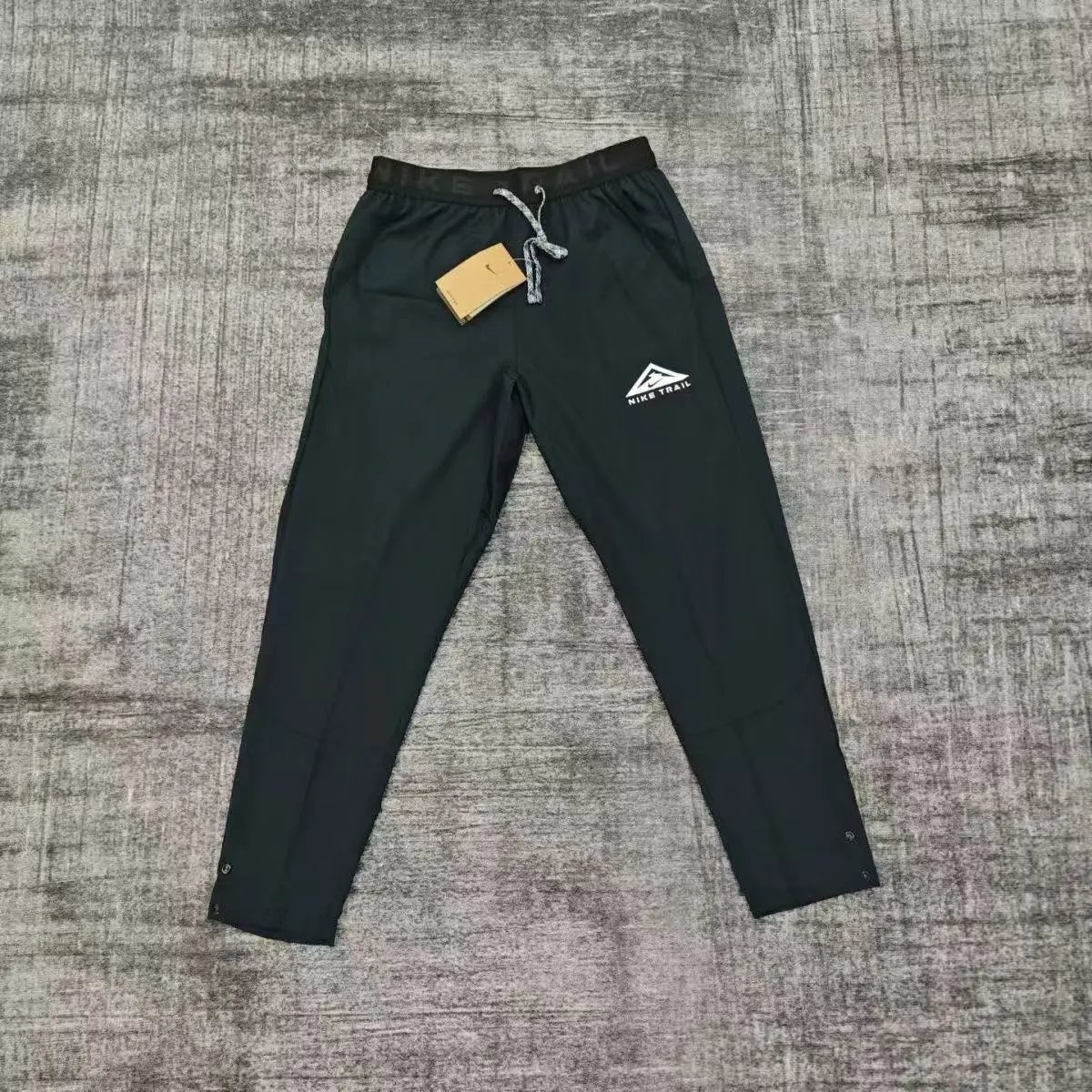 Nike Trousers Tapered running with zip pockets and reflective details — 34