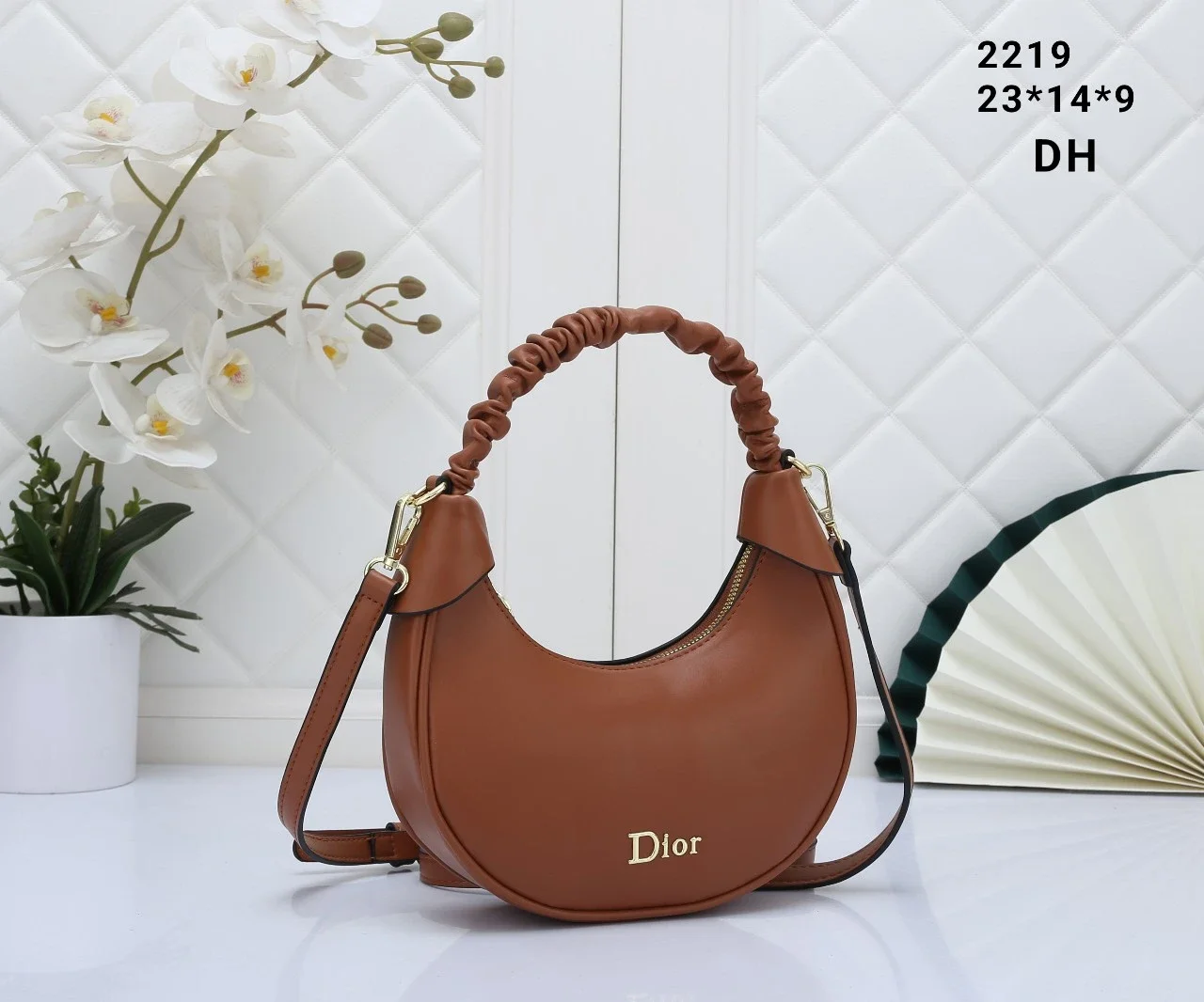 A Dior-style crescent-shaped shoulder bag