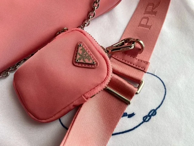 Prada Crossbody Bags Re-Edition 2000 nylon bag with detachable pouch, chain strap, and adjustable webbing strap product detail image 5