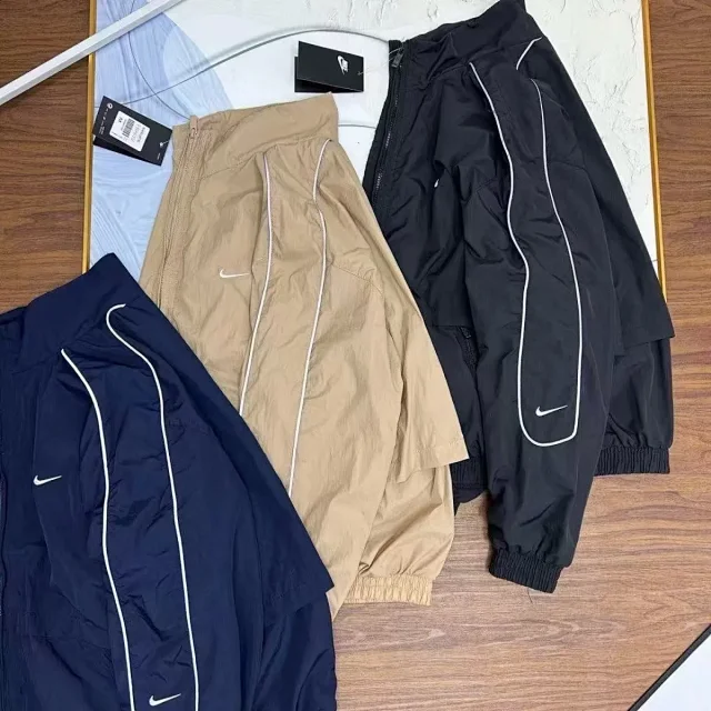 Nike Mixed apparel variants including trousers, quarter-zip tops, and a hooded puffer jacket product detail image 9