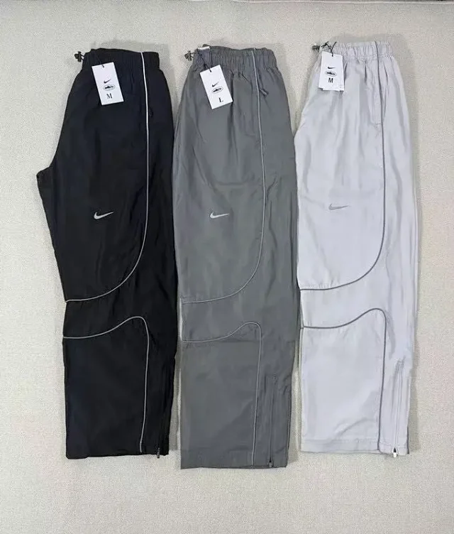 Nike Mixed apparel variants including trousers, quarter-zip tops, and a hooded puffer jacket product detail image 19