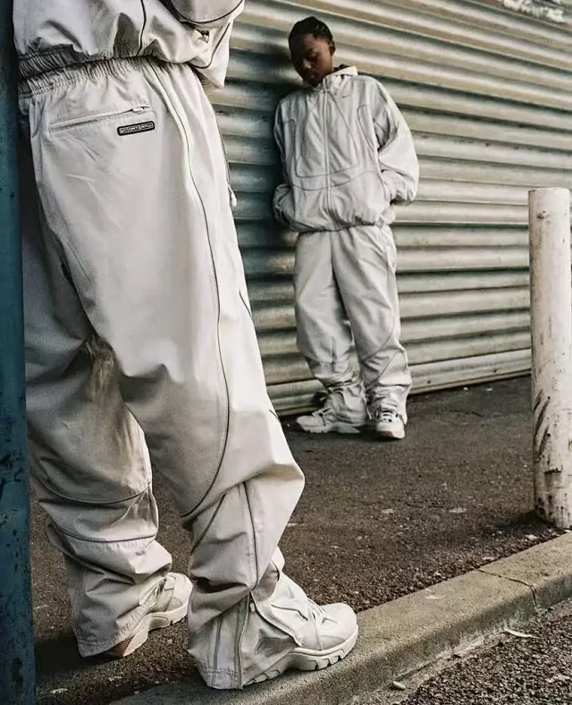 Nike Mixed apparel variants including trousers, quarter-zip tops, and a hooded puffer jacket product detail image 30
