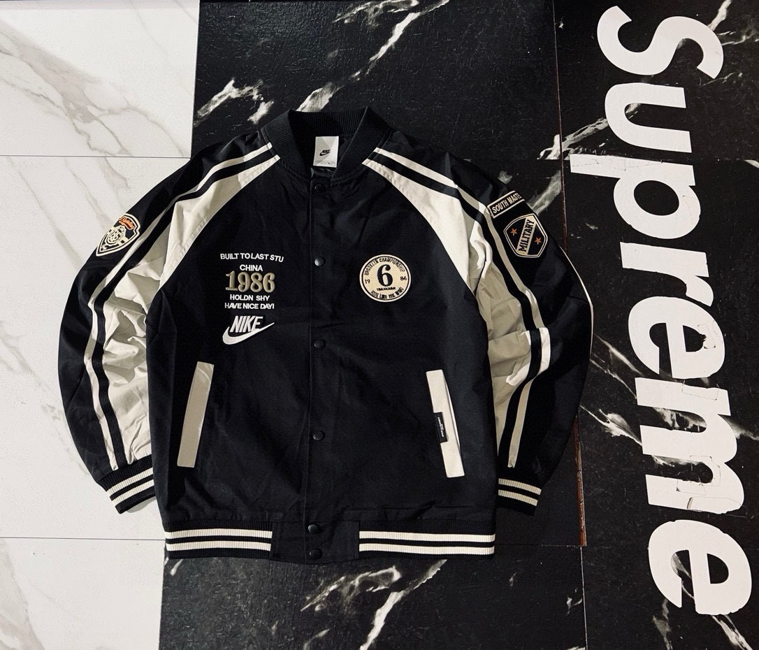 Nike Jackets Varsity-style snap-front jacket with contrast striped sleeves and patches — 1