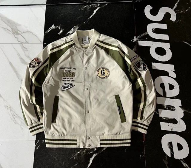 Nike Jackets Varsity-style snap-front jacket with contrast striped sleeves and patches product detail image 2