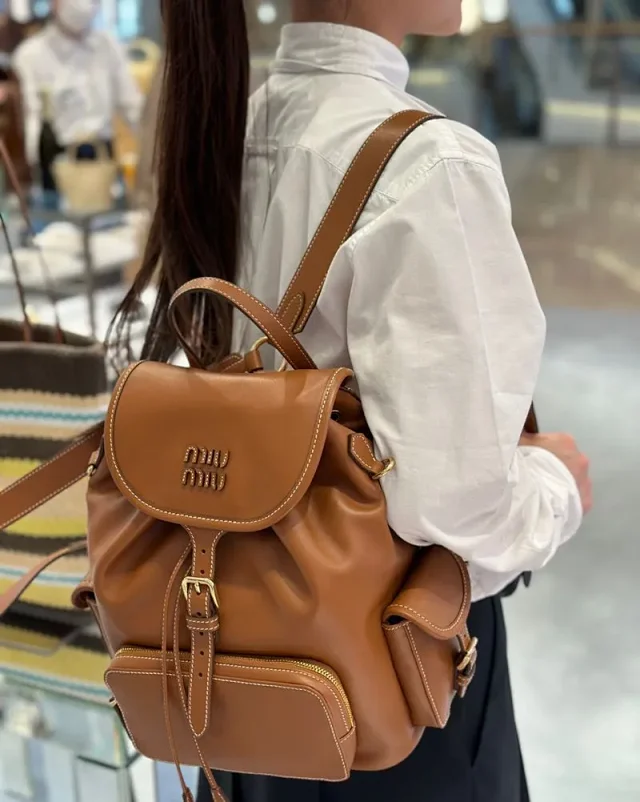 Miu Backpacks Drawstring flap backpack with front zip pocket product detail image 2