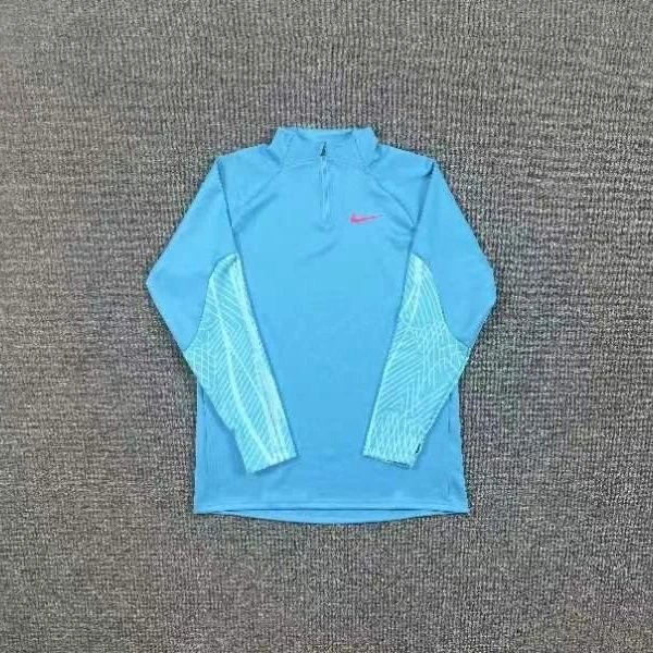 Nike Trousers Tapered athletic track pants — Blue half-zip long-sleeve