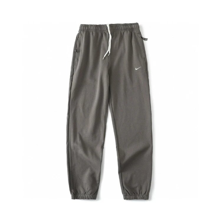 Nike Trousers Tapered sweatpants with embroidered Swoosh logo — Carbon gray
