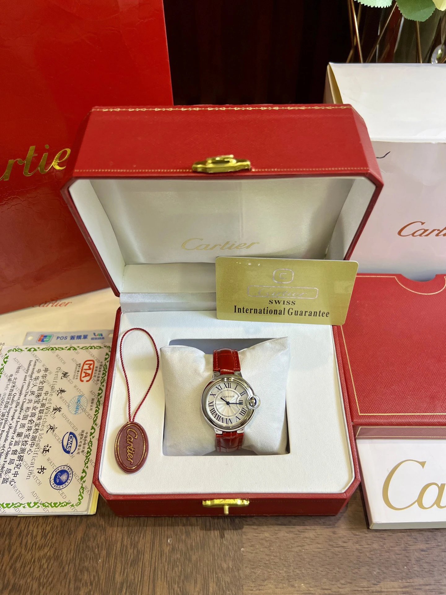 Zegarek Cartier z czerwonym skórzanym paskiem i tarczą z cyframi rzymskimi