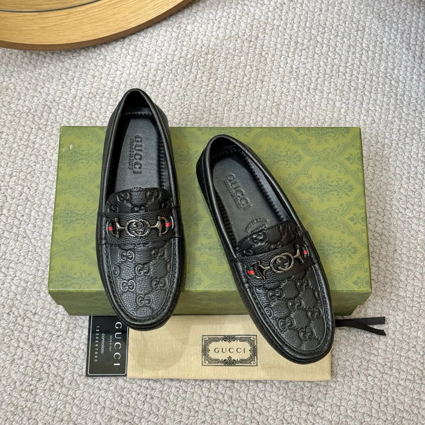 A pair of black embossed loafers from Gucci.