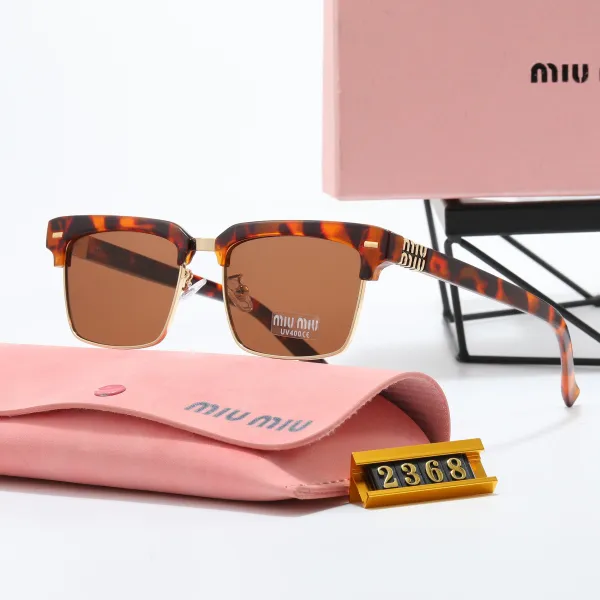 Miu Miu Tortoiseshell Acetate Sunglasses with Gold Accents - 1