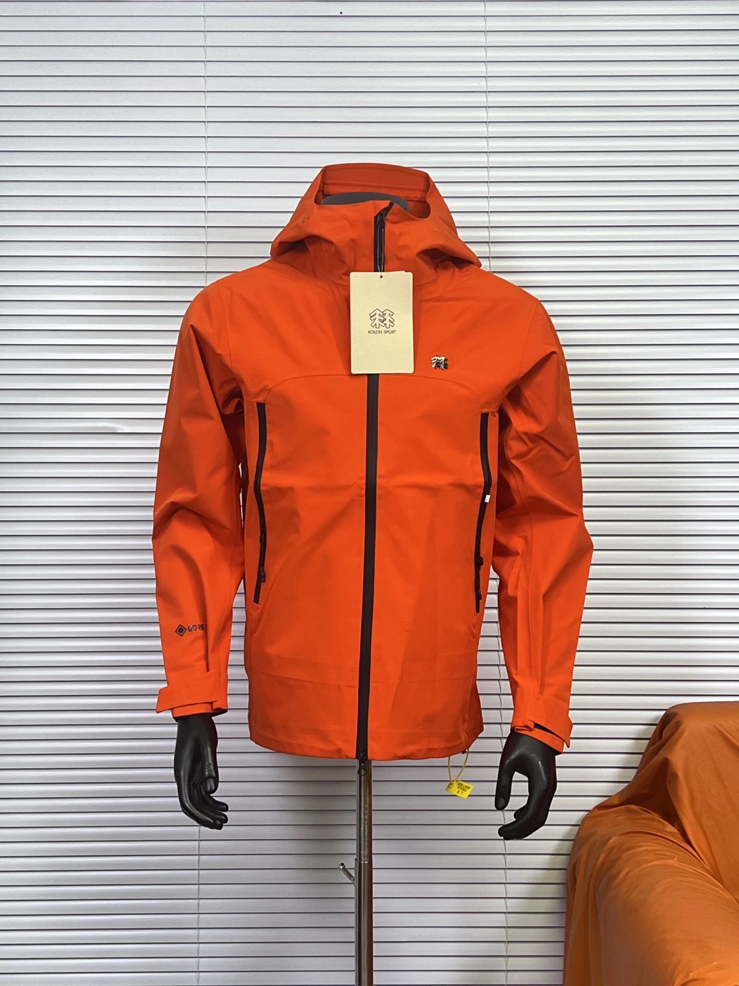 KOLON SPORT Jackets Hooded waterproof shell jacket with zip pockets — Orange
