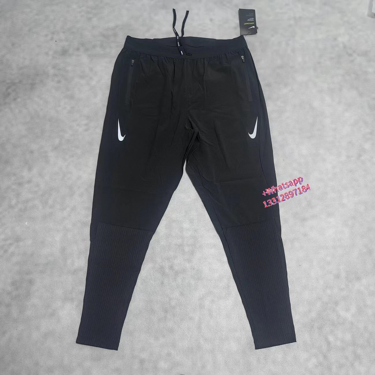 Nike Jackets Trail hooded zip-up windbreaker — Black sports pants with double white hook-and-loop stripes