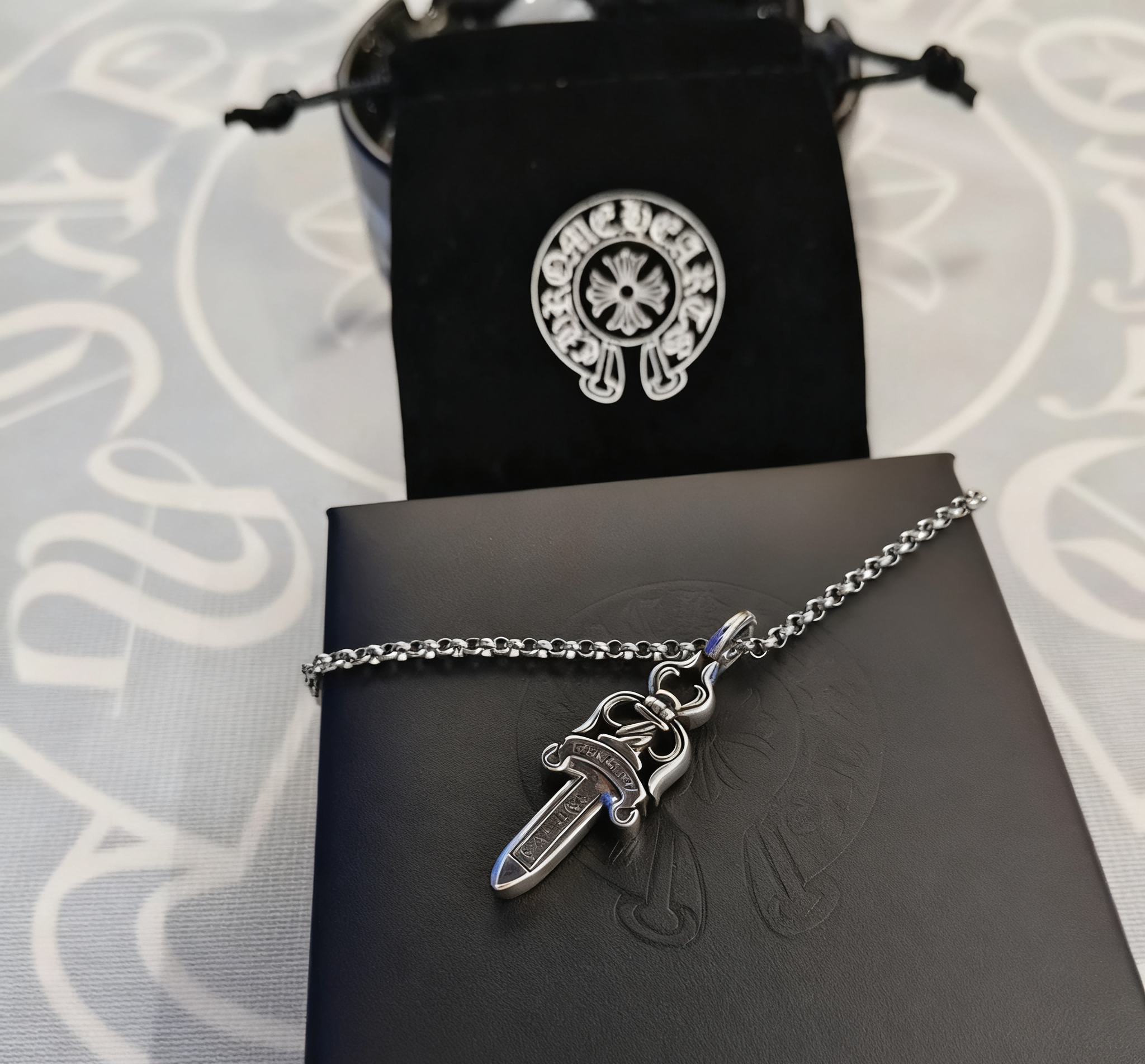 A small trumpet paired with a pearl necklace SKU image