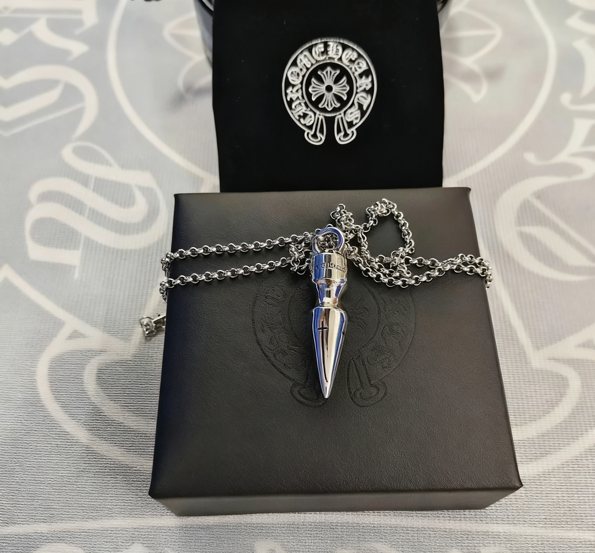 A large bullet paired with a pearl necklace SKU image