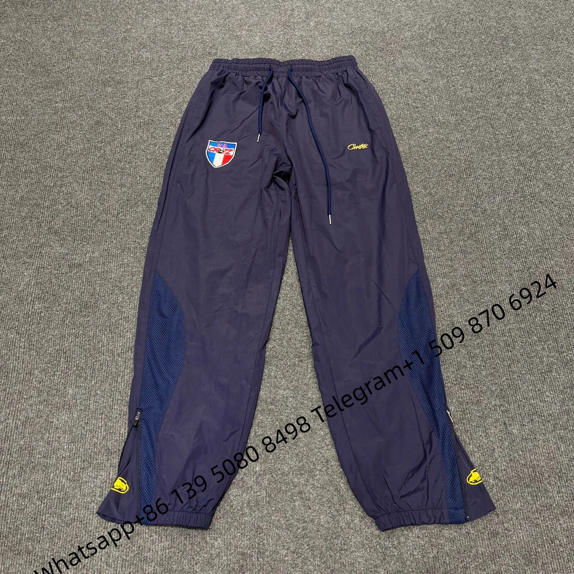 Corteiz Track Pants Navy Blue with Mesh Panels and Shield Logo