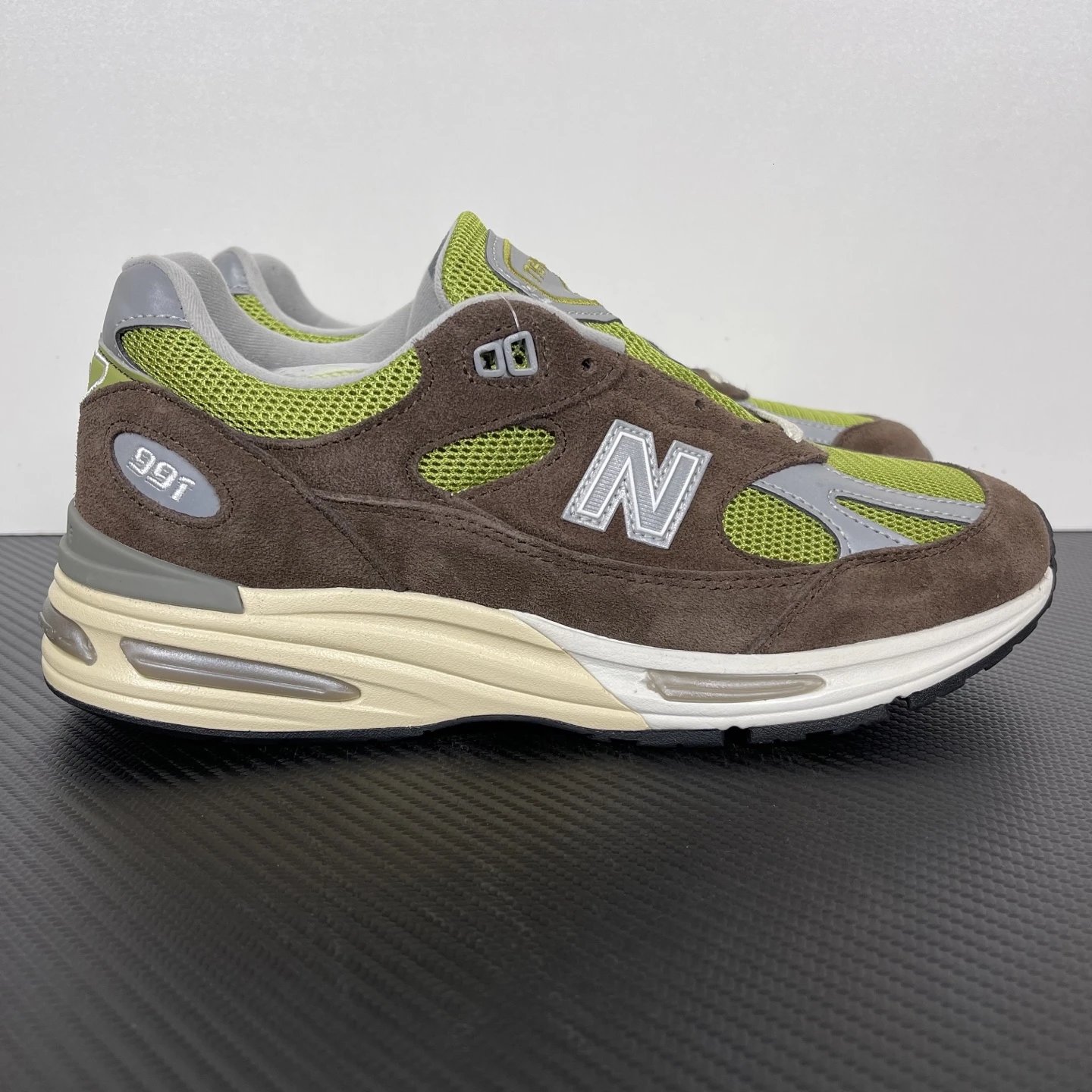 New Balance Multiple models shown — NB991 brown-green U991CK2