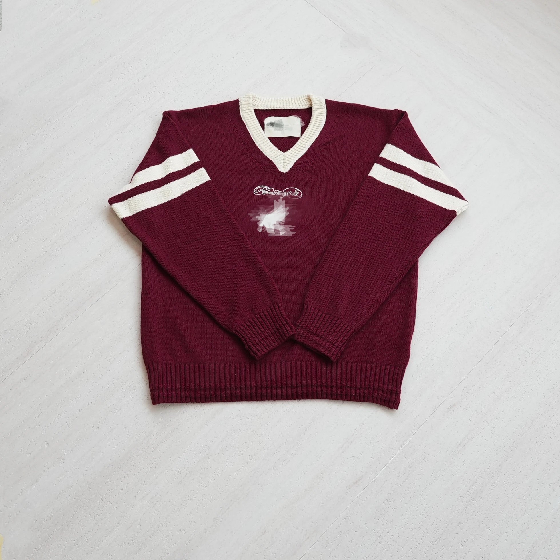 Maroon V-Neck Knit Sweater with White Stripes and Graphic Print