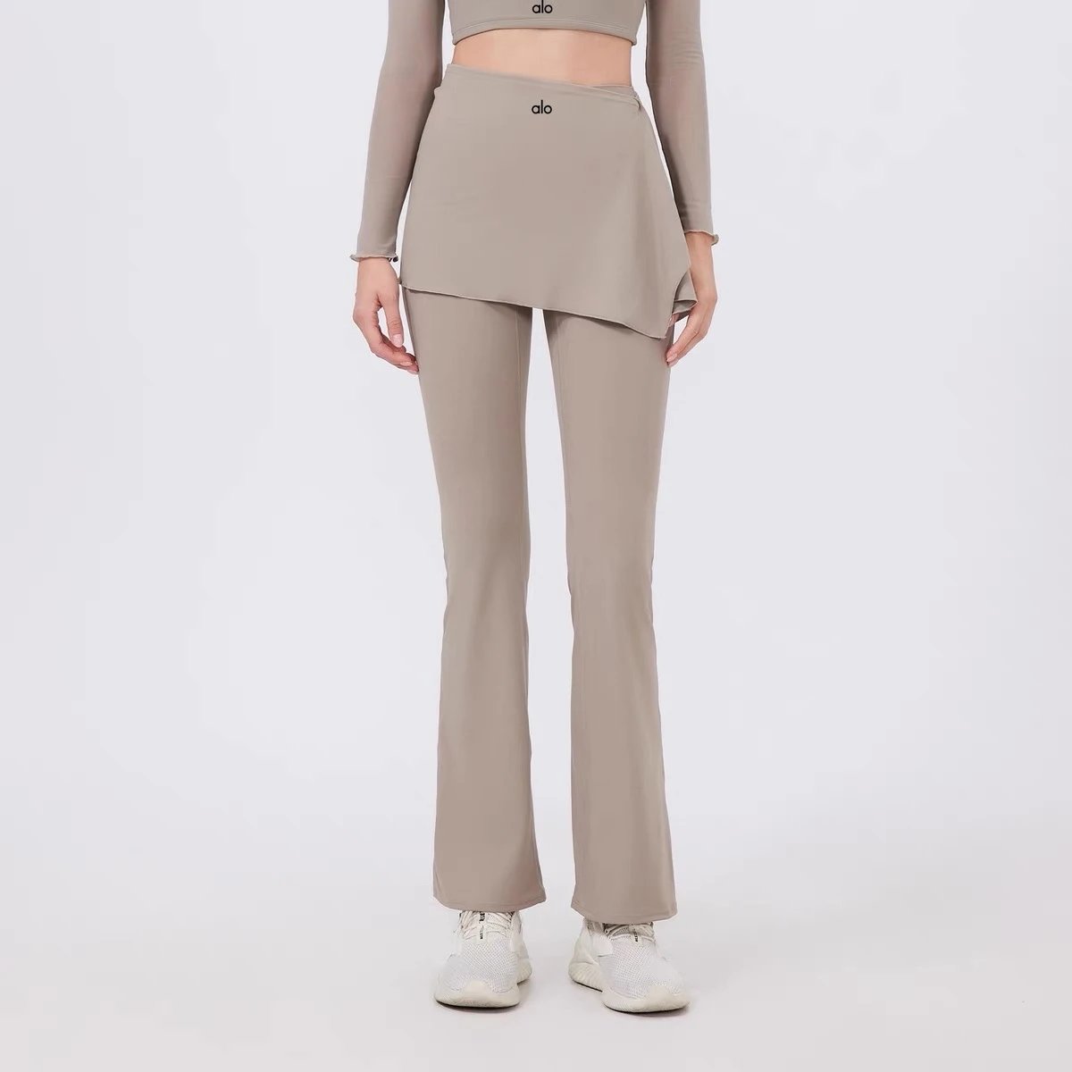 Alo Yoga Trousers High-waisted flared leggings with wrap skirt overlay — Almond color
