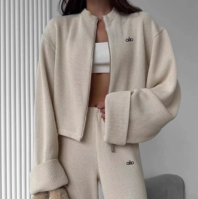 Alo Tracksuits Knitted zip-up jacket and wide-leg trousers set — Apricot color