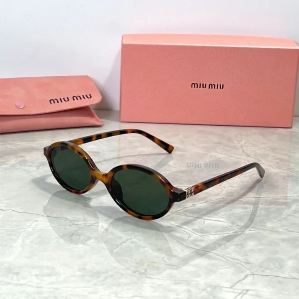 Miu Miu Round Tortoiseshell Sunglasses with Gold Accent - 1