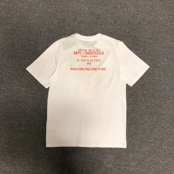 A Bathing Ape x Undefeated Camo Ape Head Orange Black T-Shirt - 7
