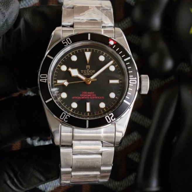 Black circle with golden letters (red font at the 6 o'clock position)