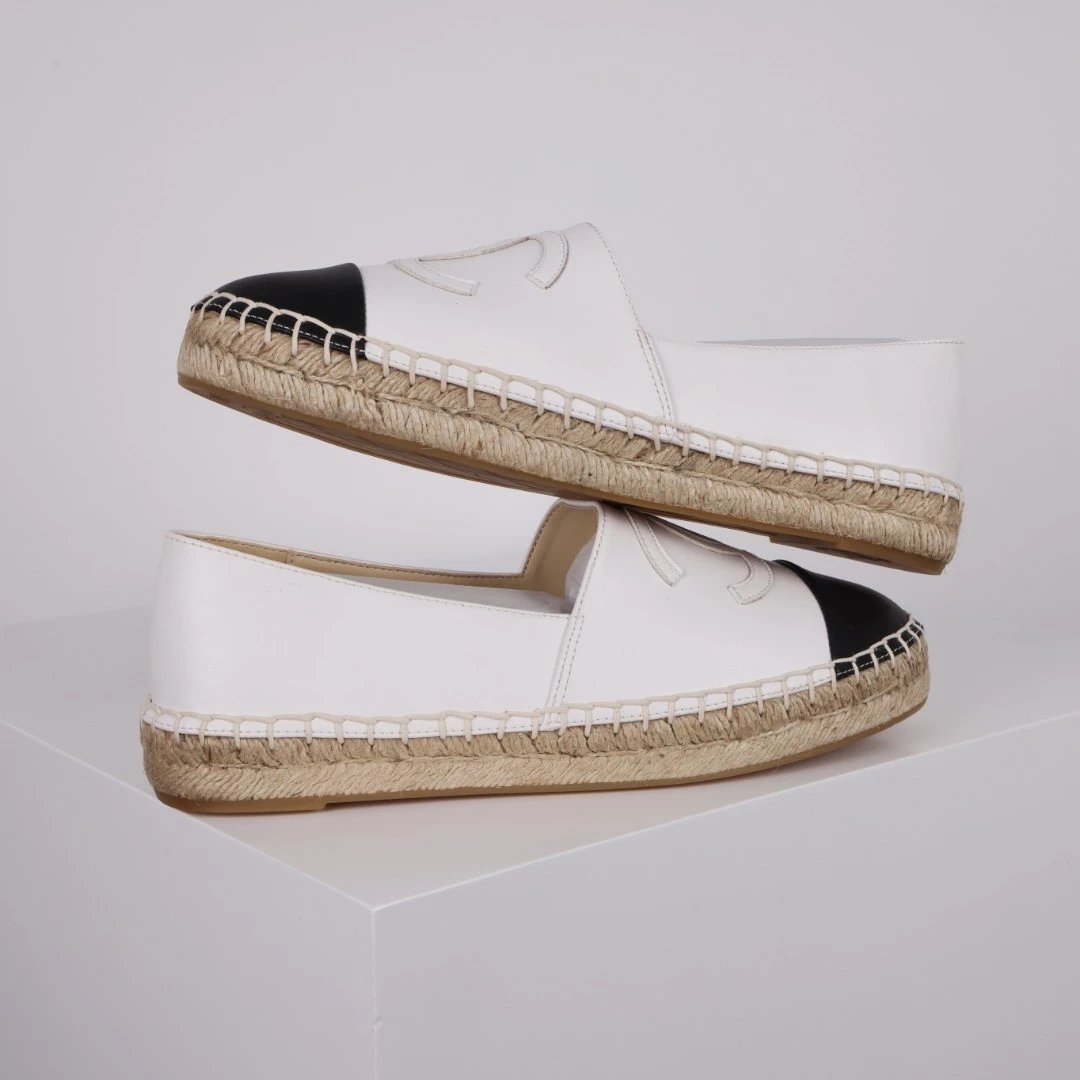 Chanel Casual Shoes Espadrille Slip-On — Black and white leather with a white label.