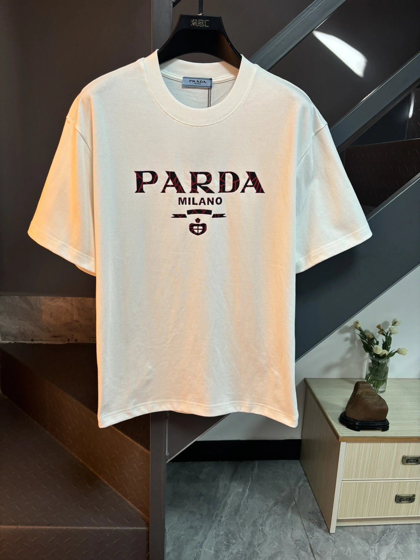 Pràda logo print cotton short-sleeved T-shirt, available in multiple colors.