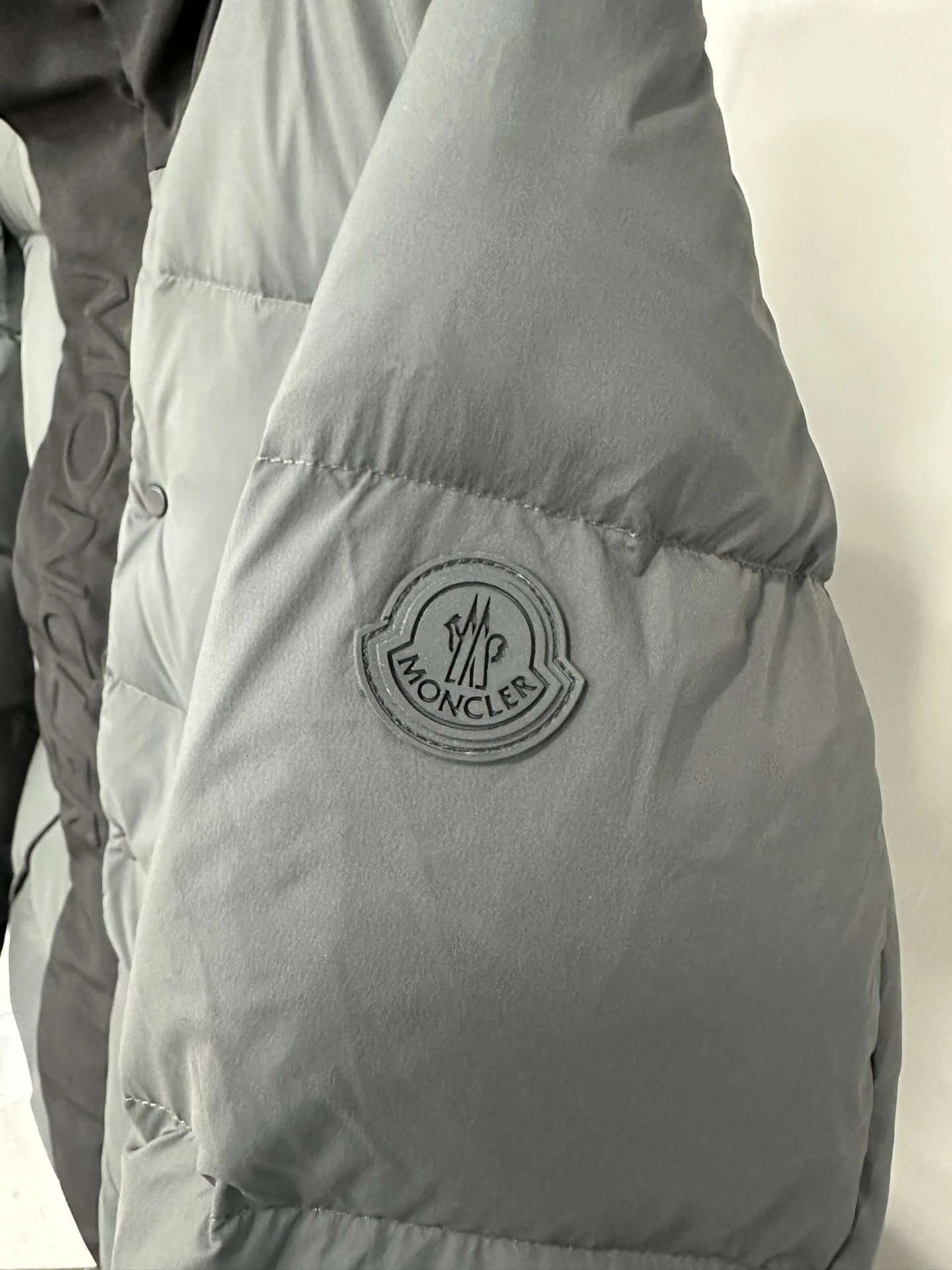Black Moncler Down Jacket with Detachable Hood and Zippered Pockets