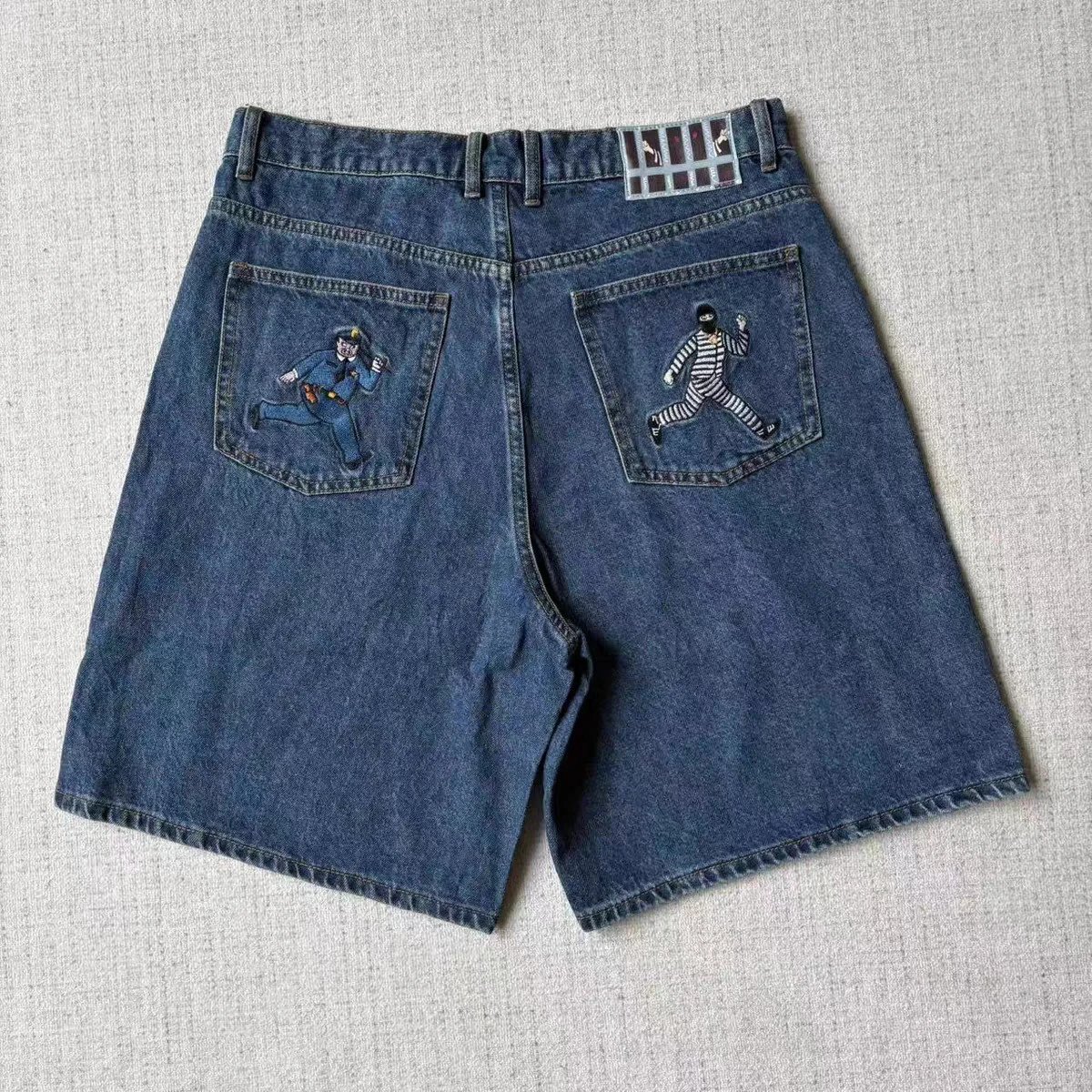 Two characters embroidered denim shorts